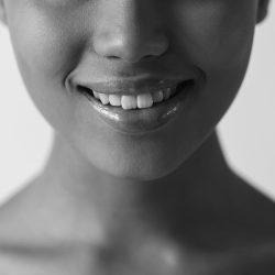 Cropped image of beautiful Afro-American girl smiling, isolated on white